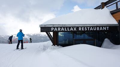 A skier passes a partially buried restaurant at Mammoth Mountain ski resort in the Sierra Nevada mountainsAFP