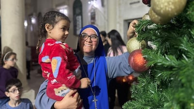 Nuns help children decorate the Christmas tree. Photo: Holy Family Church Gaza