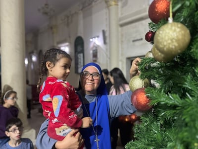 Nuns help children decorate the Christmas tree at the Holy Family Church in Gaza. Photo: Holy Family Church Gaza