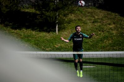 Portugal midfielder Bernardo Silva heads the ball during a training session in Oeiras. They will face Ukraine. Patricia de Melo Moreira / AFP
