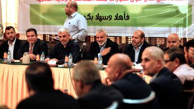 Senior political leader Ismail Haniyeh (4L) and Yahya Sinwar (3L) the new leader of Hamas in Gaza attend a meeting with leaders of Palestinian factions in Gaza City on September 25, 2017. / AFP PHOTO / MAHMUD HAMS