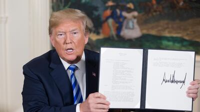 US President Donald Trump holds up a national security presidential memorandum on Iran that he just signed in the Diplomatic Reception Room of the White House in Washington, DC on May 8. Michael Reynolds / Epa