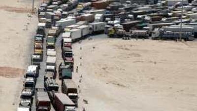 Trucks line up at the Saudi border, waiting up to five days to cross the frontier.