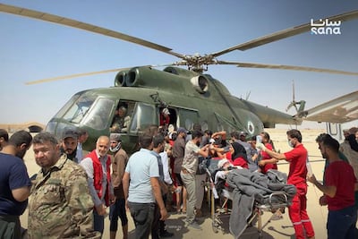 A military helicopter helps evacuate injured passengers from Palmyra Airport to the Homs Military Hospital. AFP