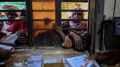 Sudanese patients receive medicine provided by volunteers at Omdurman's Al Nao Educational Hospital. AFP