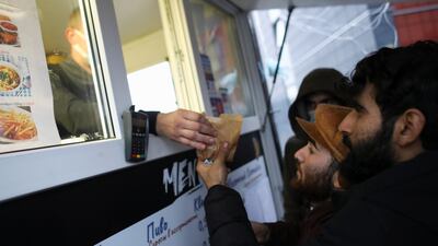 Migrants receive food near the border in the Grodno region. Reuters