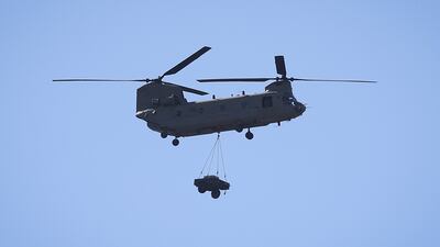 A Chinook helicopter carries an industrial generator to Pine Island. Getty / AFP