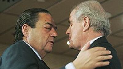 Ramon Calderon, right, embraces the vice president Vicente Boluda, who now takes charge of the club, at the end of a press conference at the Santiago Bernabeu on Friday.