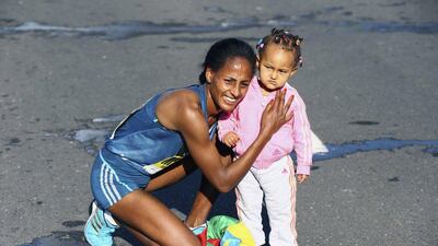 2015 Dubai Marathon winner Aselefech Mergia celebrates with her daughter after her victory in the race on Friday. Francois Nel / Getty Images / January 23, 2015