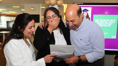 Karen Youakim celebrating with her parents after getting the IB in Silicon Oasis in Dubai. Pawan Singh / The National