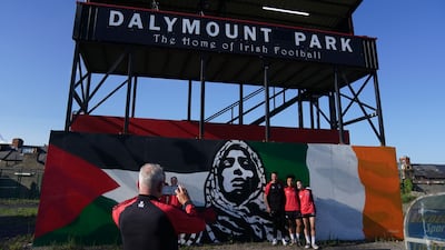 Players and staff from Bohemians Women pose by the mural. PA