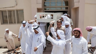 Mourners carry the body of Hayayei in July 2017, after his death in an accident in London. Antonie Robertson / The National