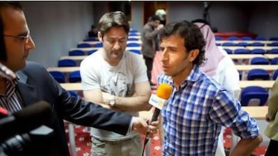 Abu Dhabi, United Arab Emirates, February 23, 2013: The Al Jazira new football coach, Spanish Luis Milla (R), speaks to a TV station during the press conference on Saturday, Feb. 23, 2013, which introduces him to the media, at the Mohamed Bin Zayed Stadium in Abu Dhabi Silvia Razgova / The National