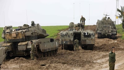 Israeli soldiers and their tanks are seen monitoring the area of the southern Israeli kibbutz of Nir Am, near the border with Gaza, on February 18, 2018. Menahem Kahana / AFP