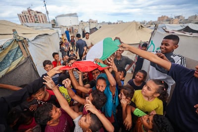 Palestinian children celebrate in Nuseirat in the central Gaza Strip on October 9, following the ceasefire announcement. AFP