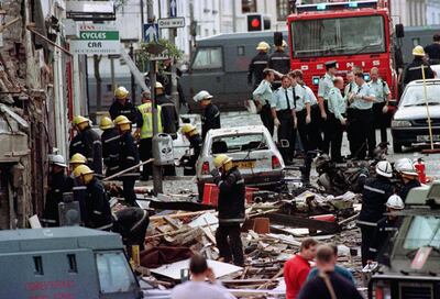 Police officers and firefighters inspect damage in the aftermath of the 1998 Omagh bombing. PA