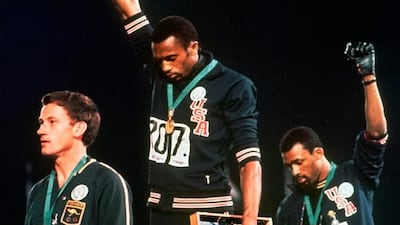 Tommie Smith, centre, and John Carlos, right, protest at the 1968 Olympics AP