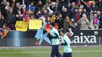 Lionel Messi trains with Gerard Pique and Barcelona on Friday. Gustau Nacarino / Reuters