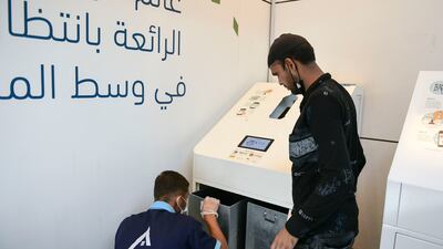Rabi Rayrajput, who works in housekeeping at World Trade Centre Mall, empties the Cycle machine.
