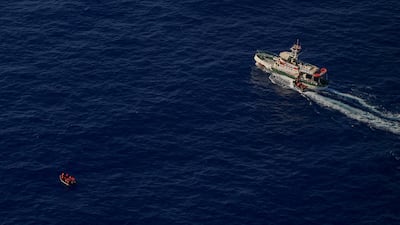 The Sea-Eye 5 rescue vessel sails near a migrant boat during a search and rescue operation, in the central Mediterranean Sea on October 3. Reuters