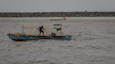 A fisherman secures his boat as typhoon Goni intensifies in Manila Bay, Manila, Philippines. EPA