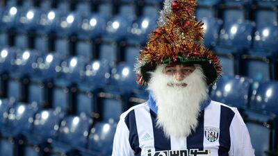 A West Brom fan wearing a festive hat and beard is pictured before the match. Oli Scarff / AFP