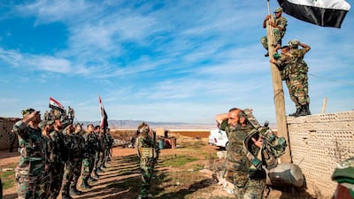 Syrian government soldiers perform a salute as others raise up a government national flag upon a wooden pole as they deploy for the first time in the eastern countryside of the city of Qamishli in the northeastern Hasakah province. AFP