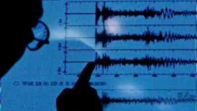 A Japanese scientist points at a graph of the reverberations from the nuclear testing in North Korea.
