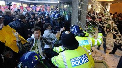 Organizers said 50,000 students, lecturers and supporters were demonstrating against plans to raise the cost of studying at a university to 9,000 pounds (Dh53,000) a year – three times the current rate. Above, police and demonstrators confront each other in the foyer of the Conservative Party headquarters building in central London.
