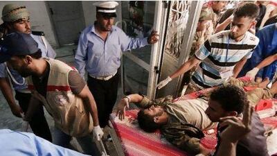 A Libyan rebel wounded during the battle for the control of the Brega oil town is rushed into the emergency room of a hospital in Ajdabiya yesterday. Gianluigi Guercia / AFP Photo