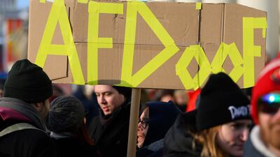 A participant carries a placard at a demonstration against the AfD and right-wing extremism in Kassel, Germany. AP