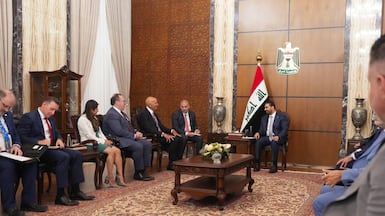 Iraq's new Prime Minister Ali Al Zaidi, centre, and US envoy for Syria and Iraq and ambassador to Turkey Tom Barrack, fifth from left, in Baghdad. AFP