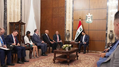 Iraq's new Prime Minister Ali Al Zaidi, centre, and US envoy for Syria and Iraq and ambassador to Turkey Tom Barrack, fifth from left, in Baghdad. AFP