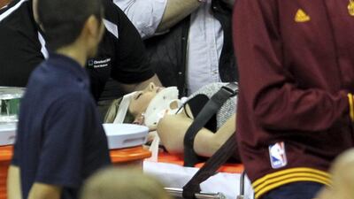 Ellie Day, wife of PGA Tour golf player Jason Day, is carried off the floor in a stretcher after Cleveland Cavaliers' LeBron James collided with her. AP Photo