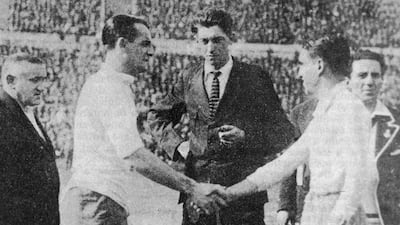 Uruguay captain Jose Nazassi, left, shakes hands with his Argentinian counterpart 'Nolo' Fereyra before the final of the first World Cup competition in Montevideo, which Uruguay won . With them is referee John Langenus and linesmen Saucedo and Henry Christophe. Photo: Getty Images