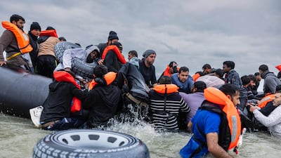 People board a smuggler's boat in an attempt to cross the English Channel in northern France. AFP