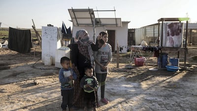 Al Poraa resident Fatma is pictured with her children outside their home on February 2, 2018. Heidi Levine