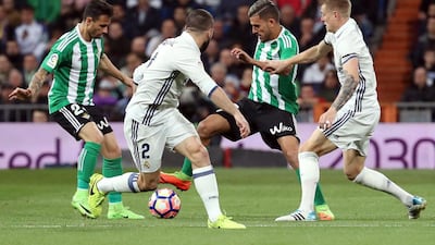 Dani Ceballos, second right, and Ruben Castro, left, of Betis vie for the ball with Real Madrid’s Toni Kroos, right, and Dani Carvajal. JJ Guillen / EPA