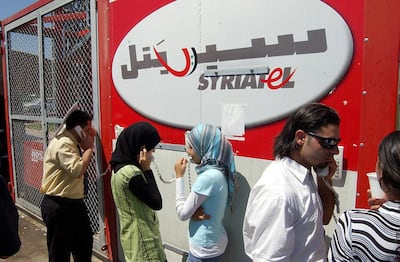 Lebanese refugees fleeing a war between Hezbollah and Israel at the Syrian-Lebanese border use Syriatel to talk with their relatives on July 25, 2006. AP