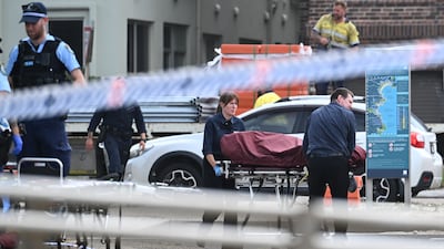 Police and forensics staff begin the task of retrieving bodies from the scene. EPA