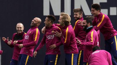 Barcelona players share a light moment as they take part in a team training session. Alberto Estevez / EPA