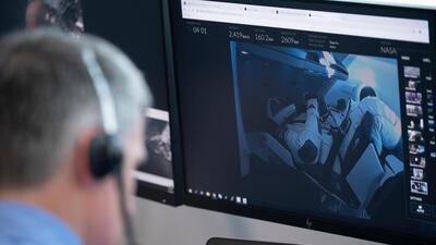 In this image released by Nasa, astronauts Robert Behnken and Douglas Hurley are displayed on a monitor as they sit inside the Dragon crew capsule during the successful launch of a SpaceX Falcon 9 rocket at the Launch Control Centre at Kennedy Space Centre in Cape Canaveral, Florida. AP