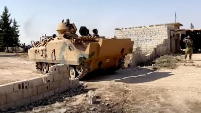 A Syrian rebel tank carrying soldiers leaves their base near Tal Abyad, Syria, in this screen grab taken from video. Reuters