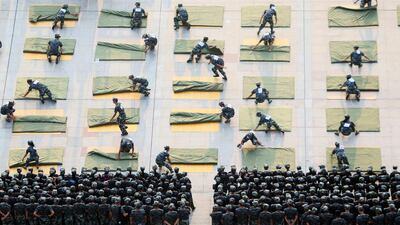 University students participate a competition of folding quilts during a military training at the start of a new semester in Hengyang, Hunan Province, China. Reuters