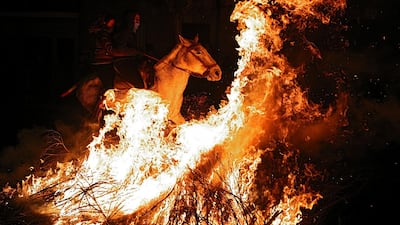 Two women ride a horse through flames during the annual 'Luminarias' celebration on the eve of Saint Anthony's day in the village of San Bartolome de Pinares, northwest of Madrid. Juan Medina / Reuters