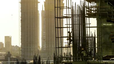 Labourers prepare reinforcing steel on an Indiabulls Real Estate commercial building construction site at dusk in the Lower Parel area of Mumbai. Dhiraj Singh / Bloomberg