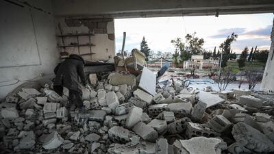 A man searches through the debris at a damaged headquarters used by the Syrian Civil Defence, also known as the "White Helmets", following reported Russian air strikes in Saraqib, east of Idlib in northwestern Syria. AFP