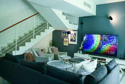 The living room space at Jad's home features plenty of seating and a flat-screen TV. Khushnum Bhandari / The National