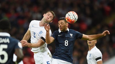 England’s Gary Cahill vies for the ball with Hatem Ben Arfa of France. Andy Rain / EPA