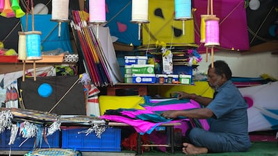 A worker makes kites at a make-shift shop ahead of Makar Sankranti kite festival in Hyderabad. AFP
